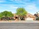 Inviting single-story home boasting mature trees, desert landscaping, and a two-car garage at 2540 Faiss Dr, Las Vegas, NV 89134