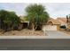 Charming single-story home showcasing lush landscaping, mature trees, and a two-car garage at 2540 Faiss Dr, Las Vegas, NV 89134