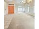 Spacious living room with tile and carpet flooring, large windows, and a chandelier at 2540 Faiss Dr, Las Vegas, NV 89134