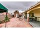 Expansive red brick backyard with a covered patio, shed, and landscaping at 2595 Fort Lauderdale Dr, Las Vegas, NV 89156
