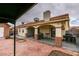 Spacious red brick backyard featuring a covered patio, a shed, and desert landscaping at 2595 Fort Lauderdale Dr, Las Vegas, NV 89156