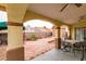 Covered patio with tables and chairs, as well as a large red brick backyard at 2595 Fort Lauderdale Dr, Las Vegas, NV 89156