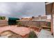 Enclosed backyard featuring brick pavers, desert landscaping, and covered patio with outdoor seating at 2595 Fort Lauderdale Dr, Las Vegas, NV 89156