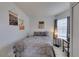 Cozy bedroom with modern decor, featuring a comfortable bed, decorative wall art, and a window for natural light at 2595 Fort Lauderdale Dr, Las Vegas, NV 89156