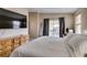 Bedroom with a bed, dresser, access to patio, and a TV mounted on the wall at 2595 Fort Lauderdale Dr, Las Vegas, NV 89156