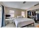 Bedroom with a bed, built-in closet, desk, neutral toned walls, and tiled floor at 2595 Fort Lauderdale Dr, Las Vegas, NV 89156