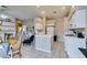 Bright kitchen featuring white cabinets, tile floors, breakfast bar, and adjacent dining area, perfect for casual meals at 2595 Fort Lauderdale Dr, Las Vegas, NV 89156