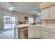 Bright kitchen with tiled countertops and modern appliances, connecting seamlessly with an outdoor patio and dining area at 2595 Fort Lauderdale Dr, Las Vegas, NV 89156