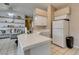 Open-concept kitchen with tiled countertops, white appliances, and ample storage, seamlessly connecting to the living area at 2595 Fort Lauderdale Dr, Las Vegas, NV 89156