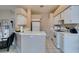Neutral-toned kitchen with white cabinets, tiled countertops, and modern appliances, creating a clean and inviting space at 2595 Fort Lauderdale Dr, Las Vegas, NV 89156