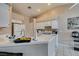 Well-lit kitchen with a tiled countertop, white appliances, and overhead cabinets, offering a functional space for cooking at 2595 Fort Lauderdale Dr, Las Vegas, NV 89156