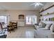 Inviting living room featuring tiled floors, a cozy sofa, and large windows at 2595 Fort Lauderdale Dr, Las Vegas, NV 89156