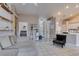 Neutral living space with a cozy sectional sofa, open shelving, and tile flooring at 2595 Fort Lauderdale Dr, Las Vegas, NV 89156