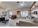 Cozy living area with tiled floors, a ceiling fan, fireplace, and a comfortable sofa at 2595 Fort Lauderdale Dr, Las Vegas, NV 89156