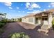Wide backyard with desert landscaping including decorative rock and lush trees at 2605 Lotus Hill Dr, Las Vegas, NV 89134