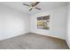 Neutral bedroom features carpet floors, a ceiling fan, and a window with views at 2605 Lotus Hill Dr, Las Vegas, NV 89134