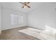 Neutral bedroom with carpet and bright, natural light from the window at 2605 Lotus Hill Dr, Las Vegas, NV 89134