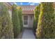 Inviting home entrance framed by manicured green trees, leading to a welcoming front door at 2605 Lotus Hill Dr, Las Vegas, NV 89134