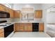 Cozy kitchen with wooden cabinets, black appliances, and bright white counter tops at 2605 Lotus Hill Dr, Las Vegas, NV 89134