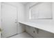 Laundry room features tile floors, a long countertop, and a white door at 2605 Lotus Hill Dr, Las Vegas, NV 89134
