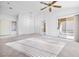 Bright, spacious living room showcasing tile and carpet flooring with sliding glass door and modern ceiling fan at 2605 Lotus Hill Dr, Las Vegas, NV 89134
