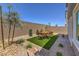 Gravel landscaping and an artificial turf lawn create an appealing backyard retreat perfect for relaxation and gatherings at 2617 Snapdragon Falls Ave # 100, North Las Vegas, NV 89081