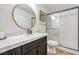 Modern bathroom featuring a vanity with quartz countertop and glass-enclosed shower at 2713 Beachside Ct, Las Vegas, NV 89117
