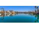Picturesque community lake surrounded by luxury homes and palm trees with mountain views in the distance at 2713 Beachside Ct, Las Vegas, NV 89117
