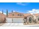 Charming two-story home featuring a tile roof, a 2-car garage, and an arched entryway for a welcoming curb appeal at 2713 Beachside Ct, Las Vegas, NV 89117