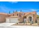Charming two-story home featuring a three-car garage, desert landscaping, and a red tile roof at 2713 Beachside Ct, Las Vegas, NV 89117