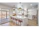 Bright kitchen featuring white cabinets, quartz countertops, and a view of the outdoor pool at 2713 Beachside Ct, Las Vegas, NV 89117