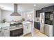 Kitchen with white and black cabinets, quartz countertops, and stainless steel appliances at 2713 Beachside Ct, Las Vegas, NV 89117
