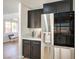 Kitchen with black cabinets, white countertops, and stainless steel appliances at 2713 Beachside Ct, Las Vegas, NV 89117