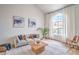 Bright living room featuring vaulted ceiling, arched windows, modern decor, and wood flooring at 2713 Beachside Ct, Las Vegas, NV 89117
