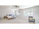 Bright main bedroom featuring a bed, accent chair, and large windows at 2713 Beachside Ct, Las Vegas, NV 89117
