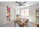 Cozy home office with modern desk, chair, shelving unit, and a large window at 2713 Beachside Ct, Las Vegas, NV 89117