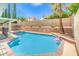 Large backyard pool with a mature palm tree, spa, and rock retaining wall at 2713 Beachside Ct, Las Vegas, NV 89117