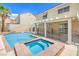 Beautiful backyard pool and spa area with a covered patio and secure pool fencing at 2713 Beachside Ct, Las Vegas, NV 89117