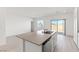 Open-concept kitchen features island with sink, granite counters, and seamlessly connects to the living area at 2727 Avril Point St, Las Vegas, NV 89156