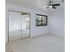 Bright bedroom with mirrored closet doors, neutral carpet, and window at 3151 Soaring Gulls Dr # 1053, Las Vegas, NV 89128
