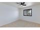 Bright bedroom featuring neutral carpet, ceiling fan and a window allowing natural light at 3151 Soaring Gulls Dr # 1053, Las Vegas, NV 89128