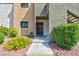 Condo entrance with lush landscaping and welcoming walkway leading to a unit at 3151 Soaring Gulls Dr # 1053, Las Vegas, NV 89128