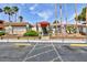 Desert Shores Villas building entrance with red awning, desert landscaping, and ample parking at 3151 Soaring Gulls Dr # 1053, Las Vegas, NV 89128