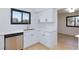 Bright kitchen featuring white cabinets, stainless steel appliances, and a large window at 3151 Soaring Gulls Dr # 1053, Las Vegas, NV 89128