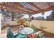 Outdoor patio with a shaded pergola and comfortable seating, perfect for relaxation and entertaining at 3425 Creek River Dr, Las Vegas, NV 89129