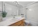 Bright bathroom features white tile, a sleek vanity, and a shower-tub combination with a shower curtain at 3425 Creek River Dr, Las Vegas, NV 89129