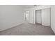 A serene bedroom with soft carpet, neutral walls, and ample closet space for organized living at 3425 Creek River Dr, Las Vegas, NV 89129