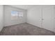Bright, carpeted bedroom with a window and a white door at 3425 Creek River Dr, Las Vegas, NV 89129