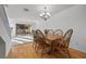 Bright dining room showcasing a wooden table with seating for six and access to the backyard at 3425 Creek River Dr, Las Vegas, NV 89129