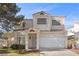 Charming two-story home with a well-manicured front yard and attached two-car garage at 3425 Creek River Dr, Las Vegas, NV 89129
